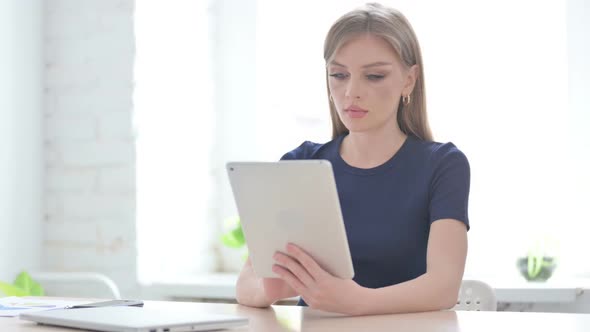 Woman Using Tablet While Sitting in Office