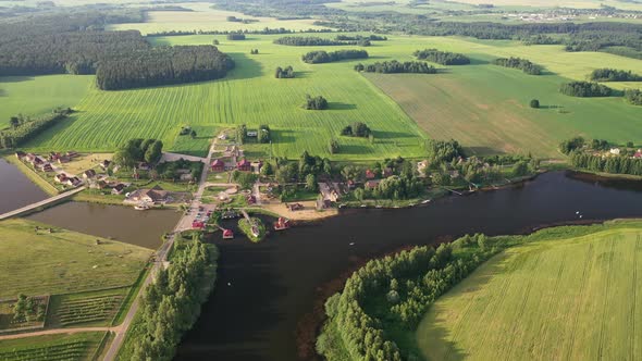 View From the Height of the Lake in a Green Field in the Form of a Horseshoe and a Village 