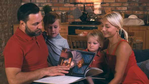 Big Friendly Family Gathered Together in a Cozy Evening To Spend Time Reading an Interesting Book