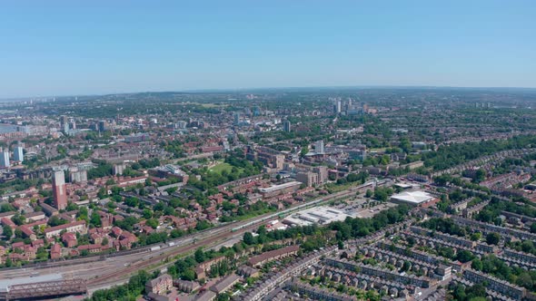 Drone shot over British rail trains in South London sunny day