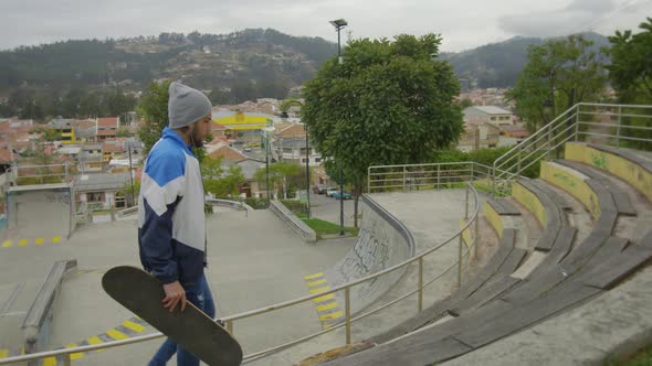 Young boy using skate board in a street park