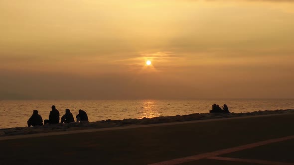 People Life In Yellow Sea Sunset Time On Beach