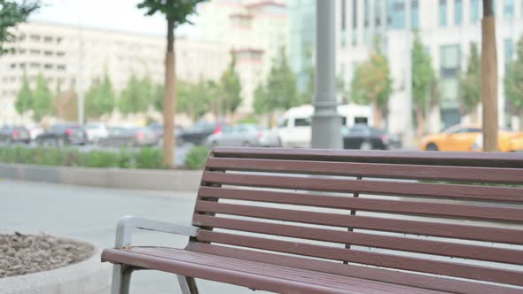 Woman Coming and Sitting on Bench Outdoor