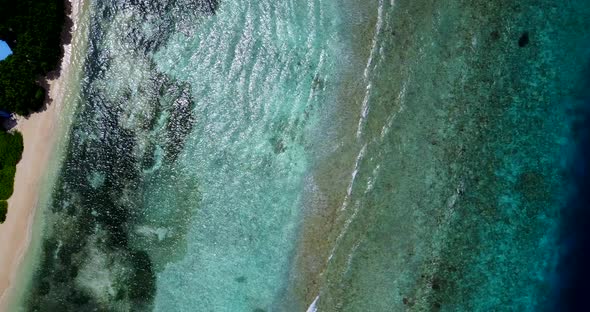 Beautiful aerial copy space shot of a sandy white paradise beach and aqua turquoise water background