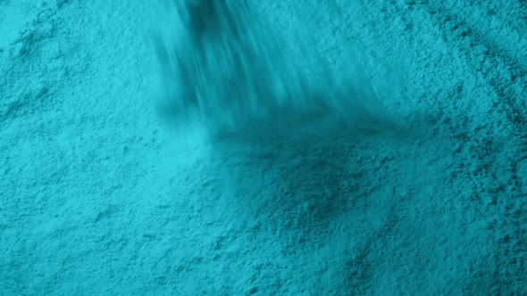 Cyan Powder Pours Into Pile