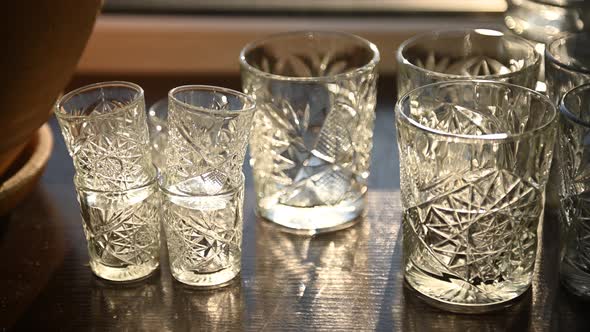 Beautiful Luxury Empty Crystal Glasses Stand on the Table Against the Background of the Sun Rays