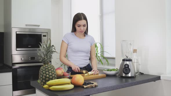 Woman Cut a Peeled Banana to Make the Smoothie