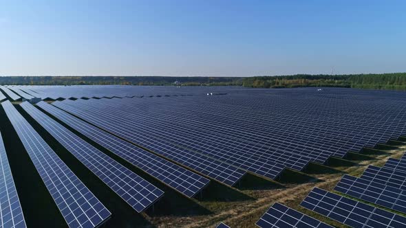 Aerial Drone Footage, Low Flight Along Solar Panel Farm, Renewable Green Alternative Energy