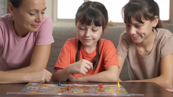 Mother with children by board game. 