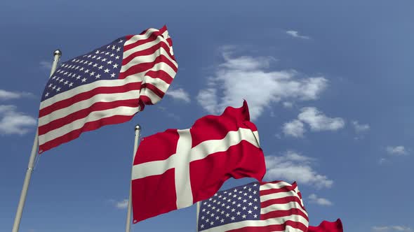 Waving Flags of Denmark and the USA on Sky Background alt