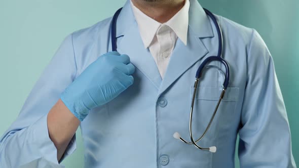 Doctor in Professional Medical Suit with Stethoscope Put on Blue Gloves