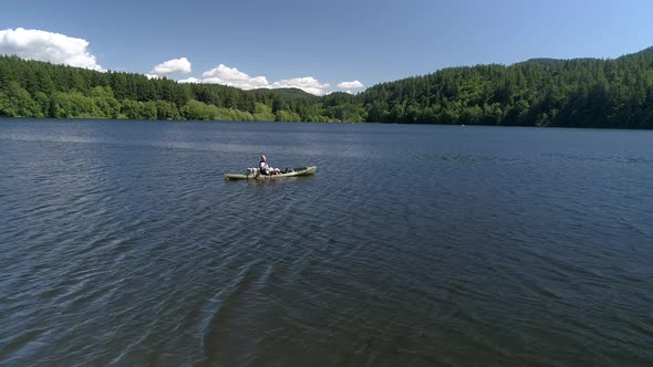 Slow Motion Fishing Aerial Of Man Casting From Kayak On Lake alt