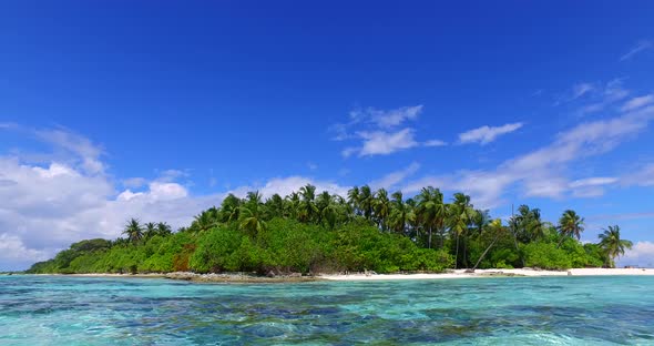 Luxury aerial travel shot of a white paradise beach and blue water background in vibrant 4K