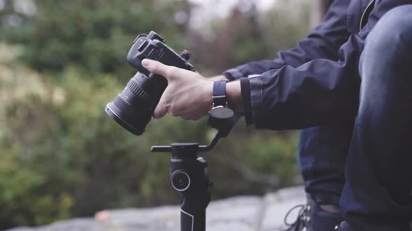 Cameraman stabilizing camera on gimbal, close up shot