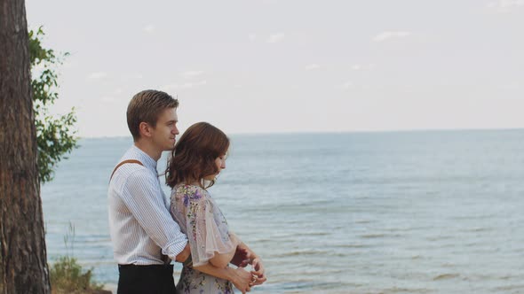 Couple in Love Hugs Medium Shot the Couple Stands Opposite Each Other with Their Eyes Closed Slow