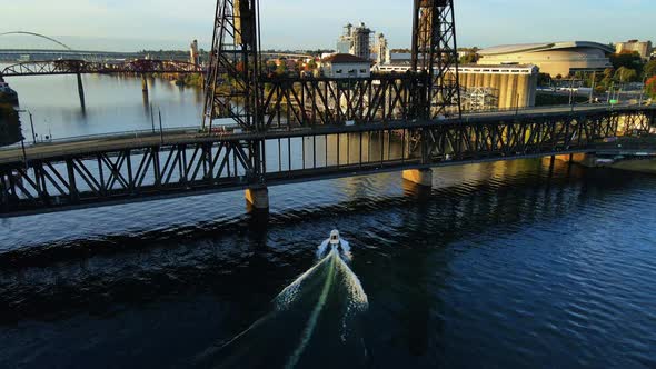 Beautiful Aerial View of Boat on Willamette River Going Under a Bridge