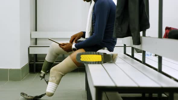 Disabled man using digital tablet in changing room 4k