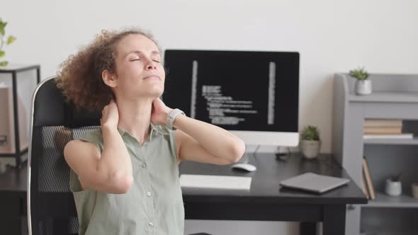 Woman Stretching Her Neck during Desk Work