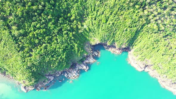 Daytime flying travel shot of a sunshine white sandy paradise beach and aqua blue water background i