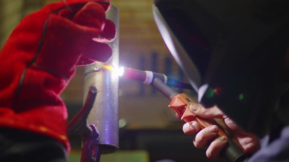 Closeup Blacksmith Welder in Protective Mask Works with Metal Steel and Iron Using a Welding Machine