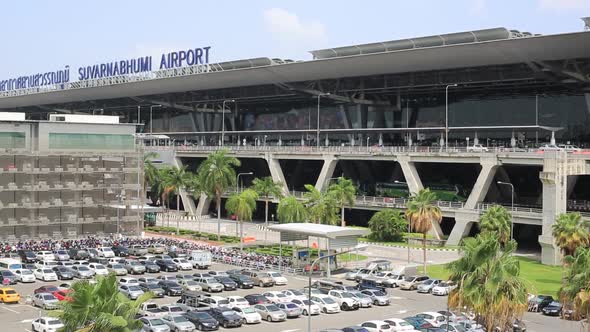 Bangkok, Thailand - Cars Parked In The Parking Lot With Palm Trees In Front Of Suvarnabhumi Airport