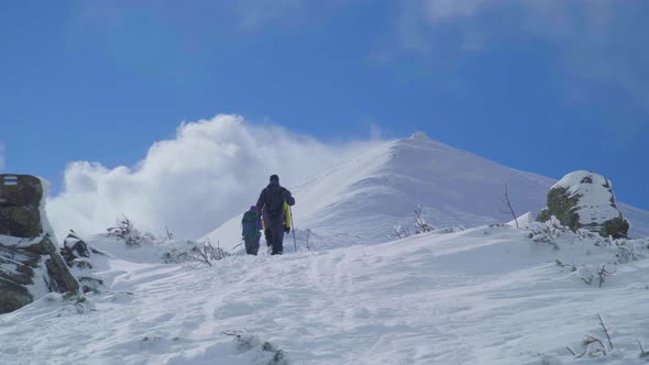 Group of Hikers Walking Towards Summit in Winter
