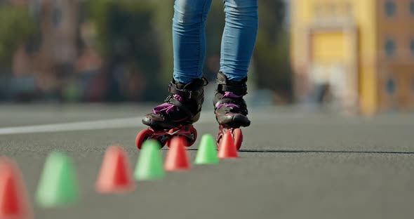 Roller Legs Make Elements of Criss-cross, Roller Skating Slalom. Professional Roller Coaching