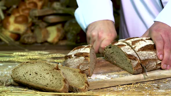 Baker in The Bakery Slices of Crusty Bread