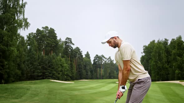 Young golfer in uniform playing golf outdoors