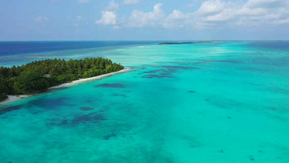 Paradise azure lagoon with calm clear water and coral reefs patterns around tropical island with lus