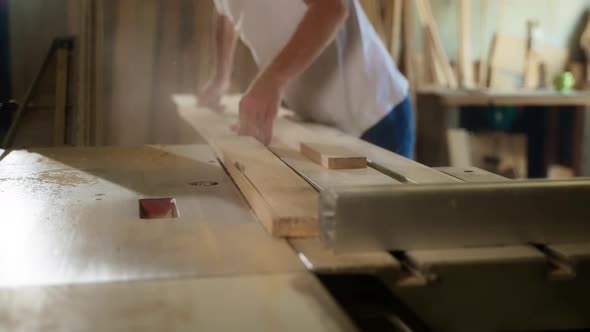 Carpenter Using Table Saw to Cut Wooden Boards