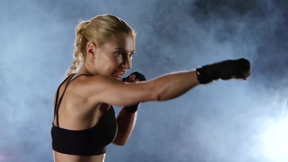 Slow Motion. Training a Boxer Girl Hands Hit the Target.