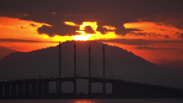 Zoom to Penang Bridge main span with sun