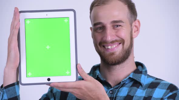 Face of Happy Bearded Hipster Man Showing Digital Tablet