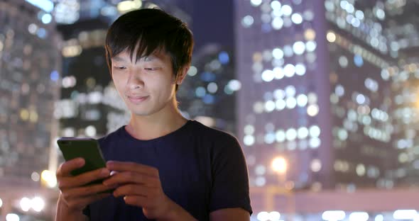 Young Man Use of Mobile Phone at Outdoor
