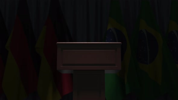 Many Flags of Brazil and Germany Behind Speaker Tribune alt