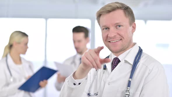 Portrait of Cheerful Male Doctor Doing Call Me Sign with Hand