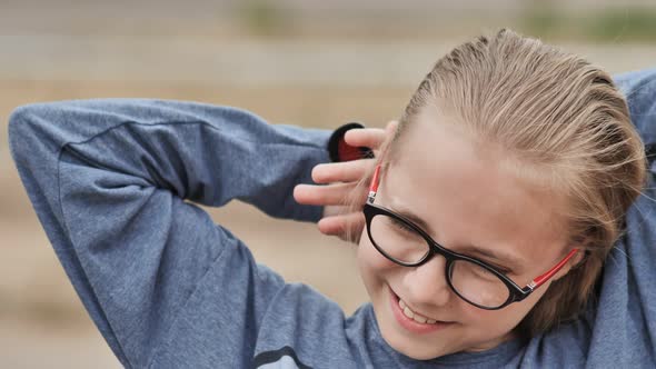 A Tenyearold Blonde Girl is Combed By a Comb