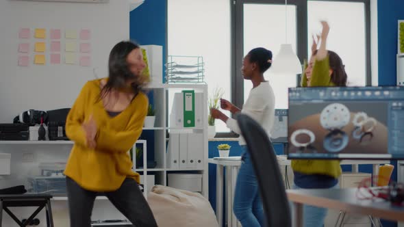 Happy Diverse Women Dancing in Company Office Celebrating Success of Project