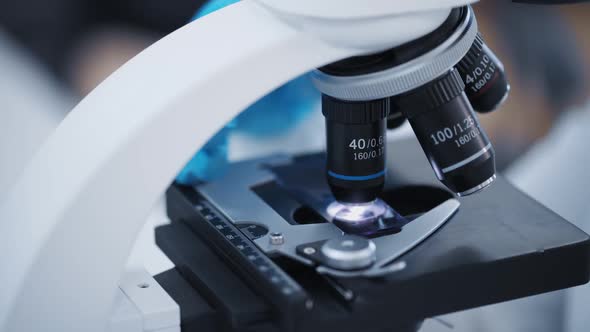 Researcher Examines Samples of a Modern Electron Diode Microscope Closeup in a Modern Biochemical