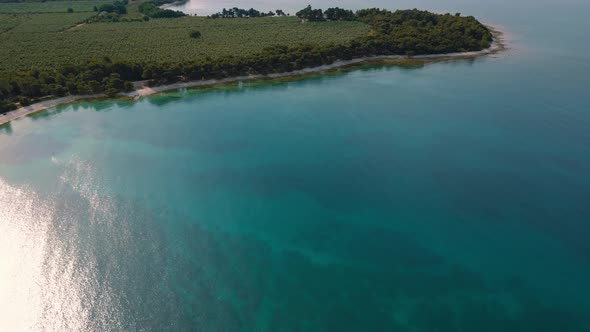 Clear blue seaside water, calm and turquoise at a natural beach coast bay in Istria, Croatia with fo