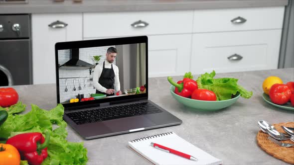 Laptop Computer with Man Food Blogger Tells Teaches Students Slices Tomato