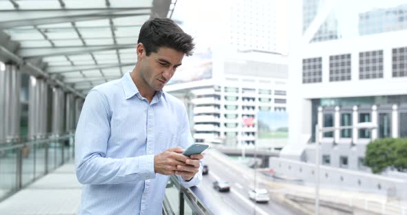 Business man use of cellphone in city