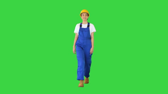 Female Construction Worker Walking and Looking to the Sides on a Green Screen Chroma Key