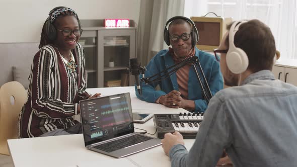 Three Multiethnic Radio Hosts Having Live Talk