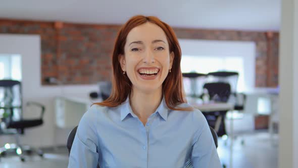 Cheerful Redhead Businesswoman Smiling at Work