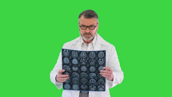 Mature Male Radiologist Reviewing Xray on a Green Screen Chroma Key