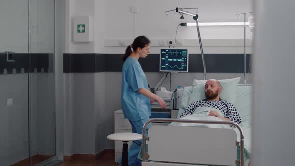 Woman Practitioner Assistant Checking Sick Man Monitoring Heartrate Pulse