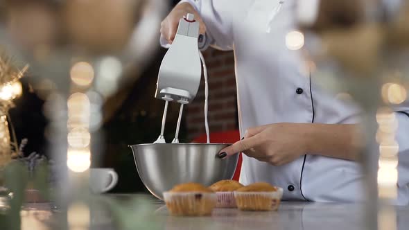 Woman Hands Mixing white Egg Cream in Bowl Using Motor Mixer