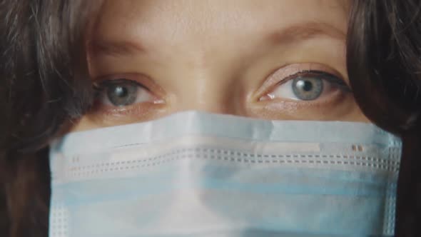 Young Woman in a Medical Mask. Eyes and Face Close Up